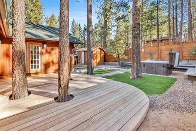 a wooden deck in front of a house with trees at Oriole House #2518 in Big Bear Lake