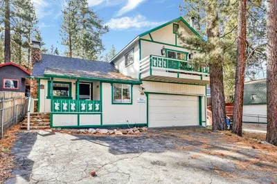 a white and green house with a garage at Green Squirrel Chateau #2484 in Big Bear Lake