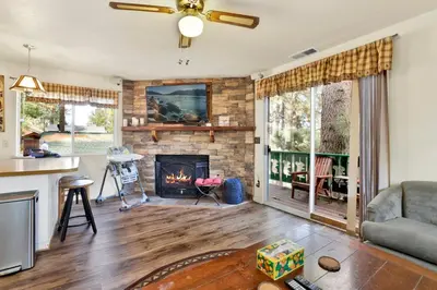 a living room with a fireplace and a couch at Green Squirrel Chateau #2484 in Big Bear Lake
