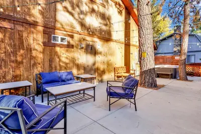 a patio with chairs and a table and a couch at Temple Bear Chalet #2507 in Big Bear Lake