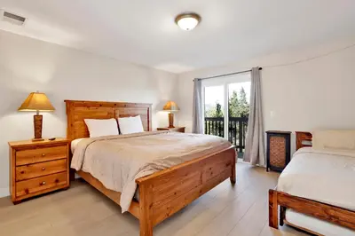 a bedroom with a large bed and a window at Temple Bear Chalet #2507 in Big Bear Lake