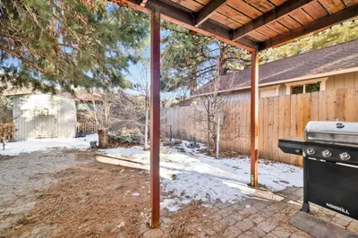 a backyard with a stove and a fence at Aeroplane Gambrel #2509 in Big Bear City