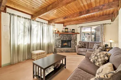 a living room with a couch and a fireplace at Aeroplane Gambrel #2509 in Big Bear City
