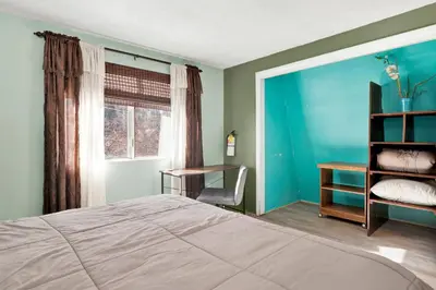 a bedroom with a bed and a desk and a window at Aeroplane Gambrel #2509 in Big Bear City