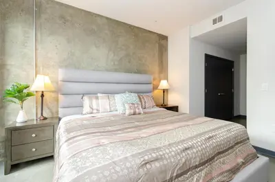 a bedroom with a large bed with pink pillows at Adorable 2bed Apt Balcony & Rooftop Pool D in Los Angeles