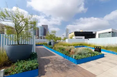 a garden with blue planters and plants at Adorable 2bed Apt Balcony & Rooftop Pool D in Los Angeles