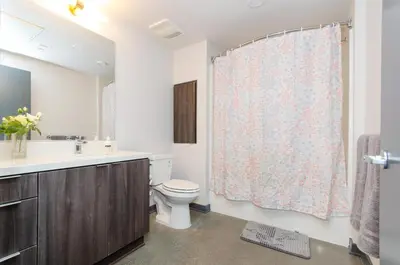 a bathroom with a toilet and a sink and a shower curtain at Adorable 2bed Apt Balcony & Rooftop Pool D in Los Angeles