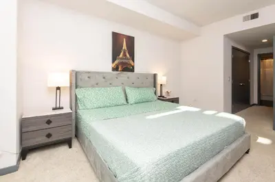 a bedroom with a bed with a eiffel tower at Lovely 3BR Apt With Balcony And Rooftop Pool Plus Views in Los Angeles