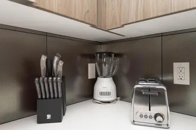 a kitchen counter with a blender and a toaster at Lovely 3BR Apt With Balcony And Rooftop Pool Plus Views in Los Angeles