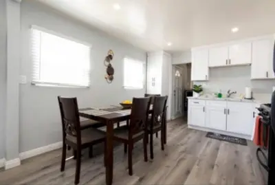 a kitchen and dining room with a table and chairs at Charming 2BR Condo with Onsite Parking Included in Los Angeles