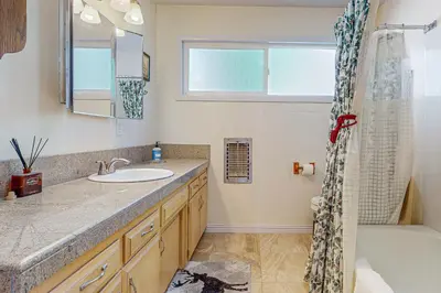 a bathroom with a sink and a shower at Tree-mendous Skypark-View Cabin in Skyforest