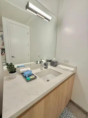 a bathroom with a sink and a mirror at Top Floor Hollywood 1BR Condo with Views in Los Angeles