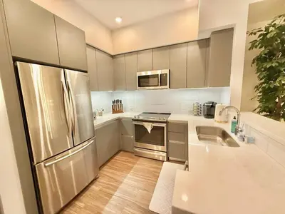 a kitchen with a stainless steel refrigerator and a sink at Top Floor Hollywood 1BR Condo with Views in Los Angeles