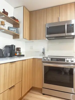 a kitchen with a stove and a microwave at 6 miles from Disney, Book your dream vacations! in Fullerton