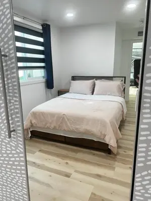 a bedroom with a bed and a mirror at 6 miles from Disney, Book your dream vacations! in Fullerton