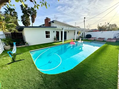 a swimming pool in the yard of a house at 4 Bed Modern Pool House with Spa & Game Room in Northridge Hospital Heliport