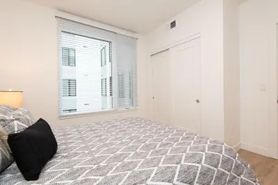 a bedroom with a bed and a window at Chic 3-bed Apt with Pool & Hot Tub in Heart of DTLA in Los Angeles
