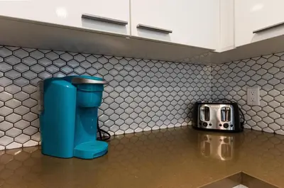 a blue toilet sitting on a counter in a kitchen at Stunning 3 Bedroom High-Rise with Pool, Spa, and Rooftop Views in Los Angeles