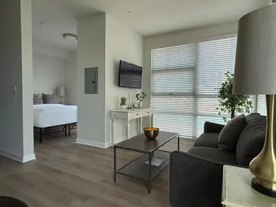 a living room with a couch and a bed at Studio Suite - Walk to Convention Center and Crypto Arena in Los Angeles