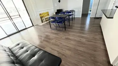 a living room with a couch and a table and chairs at The Disney Hostel - Fullerton - OC in Fullerton