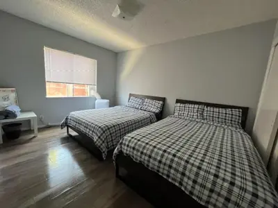 a bedroom with two beds and a window at The Disney Hostel - Fullerton - OC in Fullerton