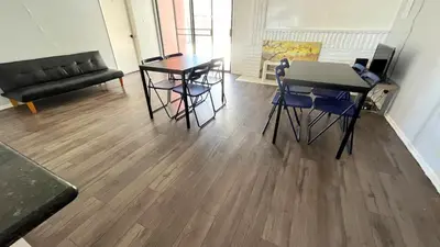 a living room with a table and chairs and a couch at The Disney Hostel - Fullerton - OC in Fullerton