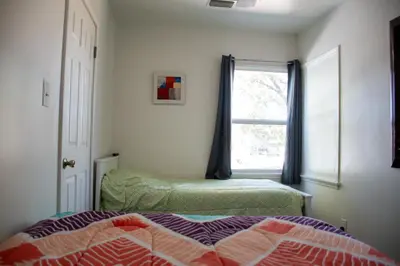 a bedroom with a bed and a window at Cozy and Relaxing in Suburbs of LA in Mission Hills