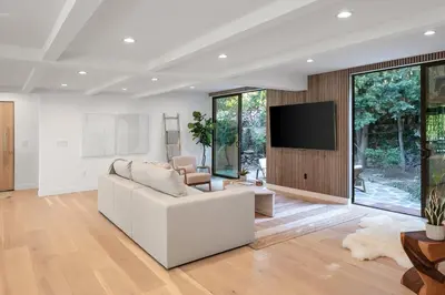 a living room with a white couch and a flat screen tv at Studio City Stunning House with 5 bedrooms, Pool, Jacuzzi, Fire-pit, Guest House in Studio City