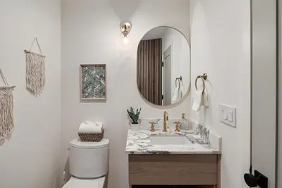 a white bathroom with a sink and a mirror at Studio City Stunning House with 5 bedrooms, Pool, Jacuzzi, Fire-pit, Guest House in Studio City