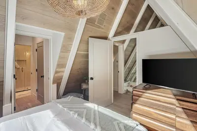 a bedroom with a bed and a large tv at Studio City Stunning House with 5 bedrooms, Pool, Jacuzzi, Fire-pit, Guest House in Studio City
