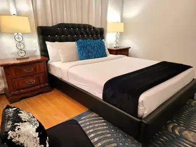 a bedroom with a large bed with a black headboard at Spacious 5BR Private Home 5 minutes to Rodeo Drive with Hot Tub Spacious Backyard Parking in Los Angeles