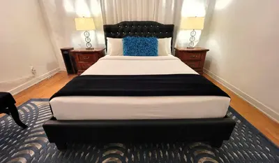 a large bed in a room with two night stands at Spacious 5BR Private Home 5 minutes to Rodeo Drive with Hot Tub Spacious Backyard Parking in Los Angeles
