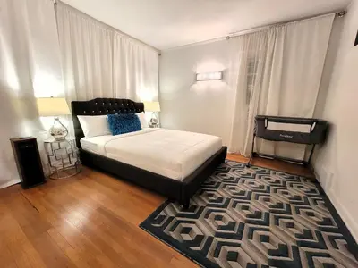 a bedroom with a bed and a rug at Spacious 5BR Private Home 5 minutes to Rodeo Drive with Hot Tub Spacious Backyard Parking in Los Angeles