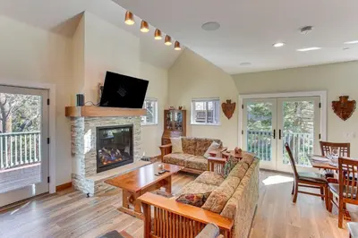 a living room with a couch and a fireplace at Game Room and Deck Pet-Friendly Lake Arrowhead Home in Lake Arrowhead