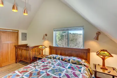 a bedroom with a bed and a window at Game Room and Deck Pet-Friendly Lake Arrowhead Home in Lake Arrowhead