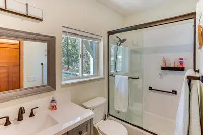 a bathroom with a shower and a toilet and a sink at Game Room and Deck Pet-Friendly Lake Arrowhead Home in Lake Arrowhead