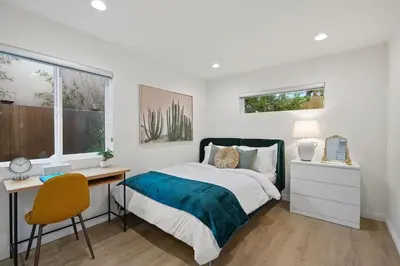 a bedroom with a bed and a desk and a window at NEW Koreatown l Universal Studios in Vernon