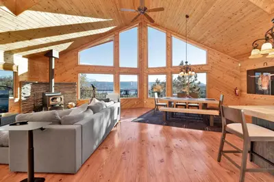 a living room with a couch and a table at High-Top Lakeview Chateau Relaxing Modern Fawnskin Retreat in Fawnskin