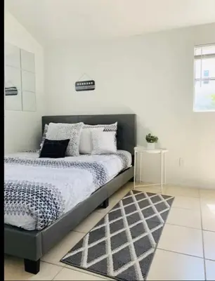 a bedroom with a bed and a rug at 4bed 2ba Hollywood house Block away from sunset, Free parking, private backyard in Los Angeles