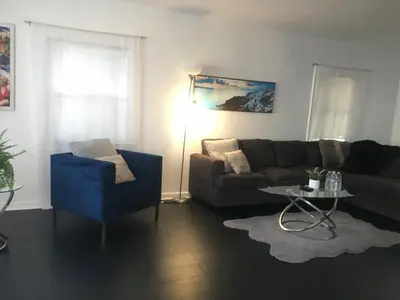 a living room with a couch and a blue chair at 4bed 2ba Hollywood house Block away from sunset, Free parking, private backyard in Los Angeles