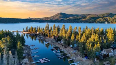 an aerial view of a lake with trees and boats at Lakefront w Private Dock Hot Tub Large Deck Views Lakeside on Lagunita in Big Bear Lake