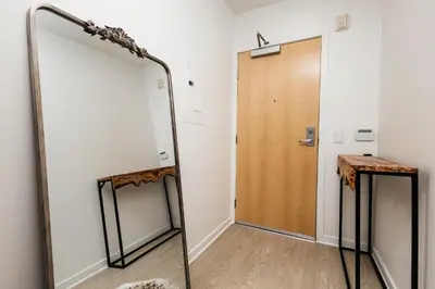 a mirror in a hallway next to a door at Seaside Serenity - Chic Santa Monica Studio in Los Angeles