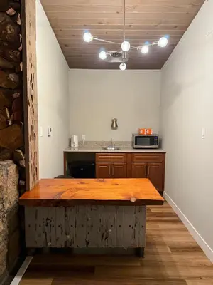 a kitchen with a wooden table in a room at Studio 9 Big Bear Lake in Big Bear Lake