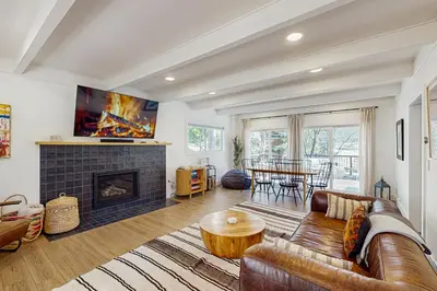 a living room with a couch and a fireplace at Arrowhead Aura in Lake Arrowhead