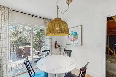 a dining room with a white table and chairs at Arrowhead Aura in Lake Arrowhead