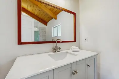 a bathroom with a sink and a mirror at Arrowhead Aura in Lake Arrowhead