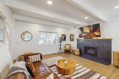 a living room with a couch and a fireplace at Arrowhead Aura in Lake Arrowhead