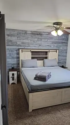 a bedroom with a bed and a ceiling fan at Alpaca Rustic Ranch-peaceful & breathtaking views in Santa Clarita