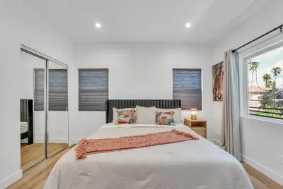 a white bedroom with a large bed and windows at Luxe Townhome Newly-Built in Sherman Oaks Community Hospital Heliport