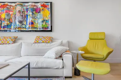 a living room with a couch and a yellow chair at 8 Santa Monica Huge Stylish Apartment in Los Angeles